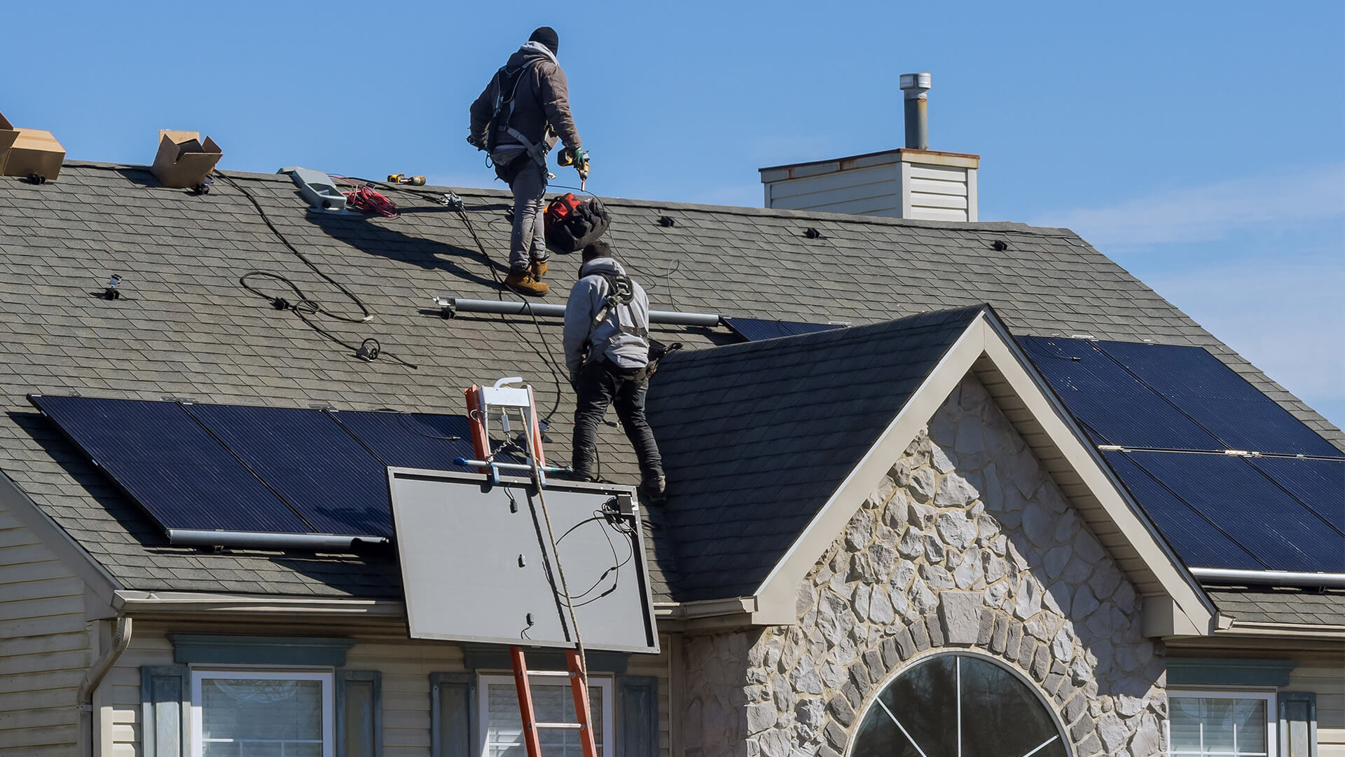 Solar panels being installed on a house